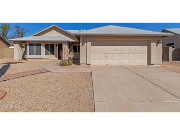 Charming single-story home featuring a two-car garage and low-maintenance desert landscaping at 1715 N Sawyer --, Mesa, AZ 85207