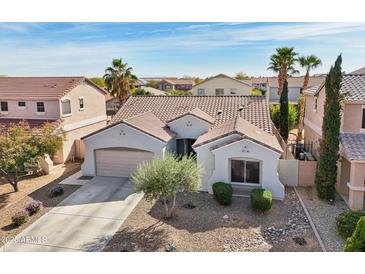 Charming single story home with desert landscaping, a two car garage, and a tile roof at 17839 W Maui Ln, Surprise, AZ 85388