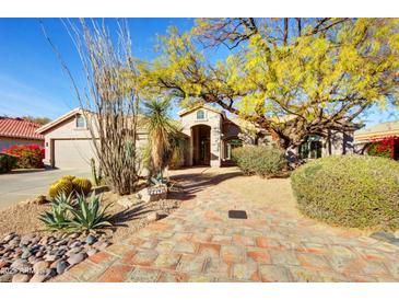 Inviting single-story home featuring desert landscaping and a charming brick pathway at 22742 N 90Th St, Scottsdale, AZ 85255