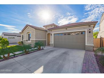 Attached two-car garage with an extended driveway and beautiful curb appeal at 23072 N 98Th Dr, Peoria, AZ 85383