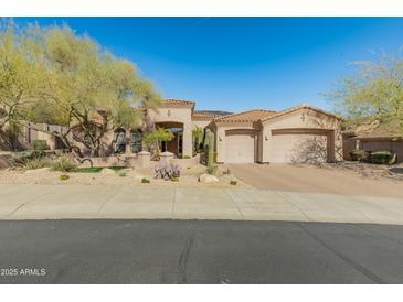 Charming home featuring a three-car garage, well-manicured desert landscaping, and a tile roof at 27561 N 84Th Dr, Peoria, AZ 85383