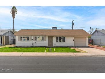 Charming single-story home with a well-maintained lawn and a one-car garage at 3117 W Corrine Dr, Phoenix, AZ 85029