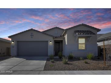 Charming single-story home showcasing a neutral color palette and low-maintenance desert landscaping at 31400 N 130Th Ave, Peoria, AZ 85383