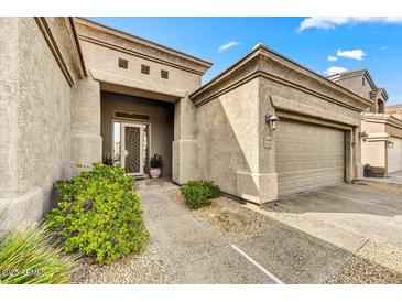 Inviting home with covered entry, beautiful landscaping, and an attached two-car garage at 34014 N 43Rd St, Cave Creek, AZ 85331