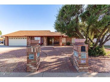 Charming single-story brick home featuring a well-maintained yard and inviting walkway at 4323 W Villa Theresa Dr, Glendale, AZ 85308