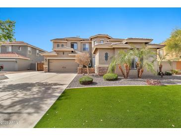 Charming two-story home with lush front yard and a three car garage perfect for Gathering living at 5110 S Sandstone St, Gilbert, AZ 85298