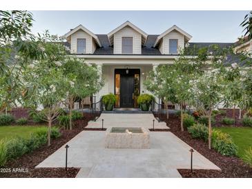 Stunning two-story home with a water feature, professional landscaping, and inviting front entrance at 5144 E Calle Del Medio --, Phoenix, AZ 85018