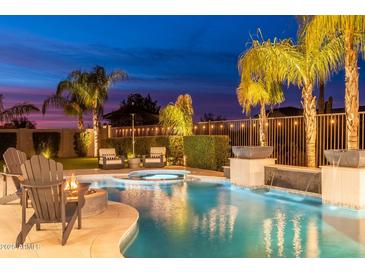 Backyard oasis with a sparkling pool, spa, and fire pit, perfect for entertaining at 5904 E Calle De Las Estrellas Rd, Cave Creek, AZ 85331