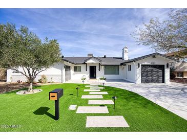 Charming single-story home featuring well-manicured landscaping, a neatly kept lawn, and a modern mailbox at 6325 N 83Rd Pl, Scottsdale, AZ 85250