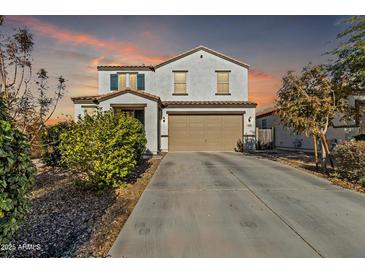 Charming two-story home with a spacious driveway and well-maintained landscaping at 1052 W Capulin Trl, San Tan Valley, AZ 85140