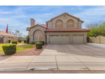 Charming two-story home with red tile roof and three-car garage at 12443 W Monte Vista Rd, Avondale, AZ 85323