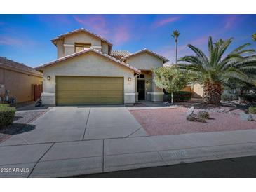 Inviting two-story home with a desert-landscaped front yard, a two-car garage, and neutral tones at 17036 N 43Rd Pl, Phoenix, AZ 85032