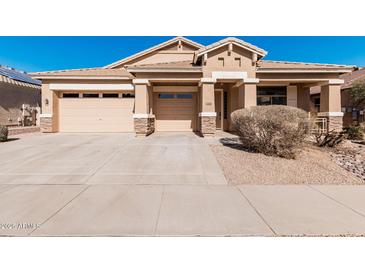 Charming single-story home with a well-manicured front yard and a two-car garage at 17642 W Pershing St, Surprise, AZ 85388