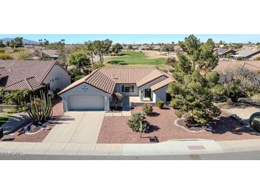 Stunning single-story home boasts a tile roof, well-manicured landscaping, and a convenient two-car garage at 21614 N 138Th Ave, Sun City West, AZ 85375