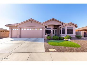 Beautiful single-story home with a three-car garage, desert landscaping, and a charming front entrance at 2854 S Berrywood --, Mesa, AZ 85212