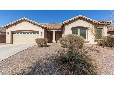 Charming single-story home with desert landscaping and a two-car garage, showcasing its inviting curb appeal at 3034 E Coconino Dr, Gilbert, AZ 85298