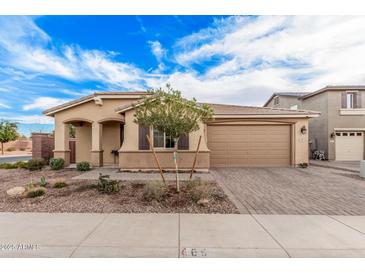 Charming single-Gathering home featuring a landscaped front yard and a two-car garage in a desirable neighborhood at 65 W Cucumber Tree Ave, San Tan Valley, AZ 85140