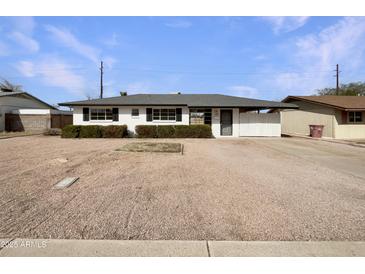 Charming single-story home with a well-manicured lawn and inviting curb appeal at 7020 E Oak St, Scottsdale, AZ 85257