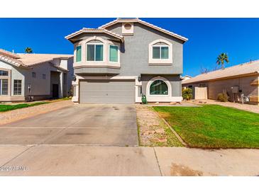 Charming two-story home featuring a well-manicured lawn and a spacious driveway at 7456 E Milagro Ave, Mesa, AZ 85209