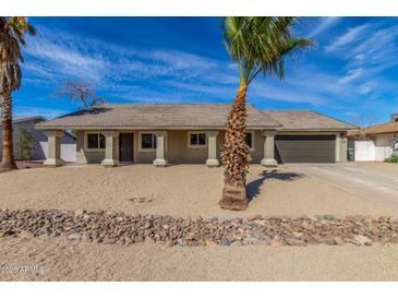 Charming single-story home featuring a desert landscaped yard with a neutral-colored facade and attached garage at 1318 E Mission Grande Ave, Casa Grande, AZ 85122