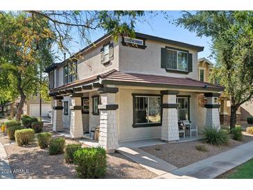 Charming two-story home featuring a cozy front porch with stylish columns and manicured landscaping at 1531 S Owl Dr, Gilbert, AZ 85296