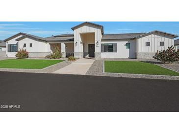 Charming single-story home featuring a landscaped front yard, gray stone accents, and a welcoming front entry at 16832 E Hazeltine Way, Queen Creek, AZ 85142