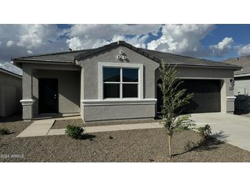 Charming single-story home featuring a neutral gray exterior, xeriscaped front yard, and attached garage at 18878 E Bruno Dr, Gold Canyon, AZ 85118