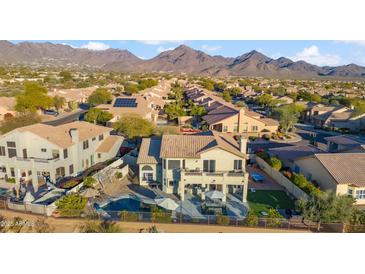 Stunning aerial view of home, showcasing the pool, patio, and mountain views at 19240 N 90Th Pl, Scottsdale, AZ 85255