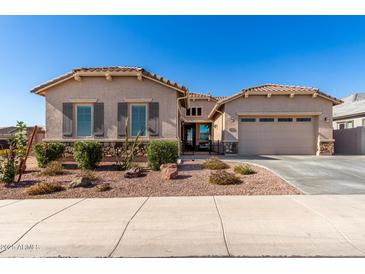 Charming single-Gathering home featuring a well-manicured front yard and a two-car garage at 3202 N 197Th Ave, Buckeye, AZ 85396