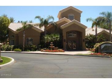Inviting clubhouse featuring a unique architectural design, lush landscaping, and a charming fountain at 5335 E Shea Blvd # 1095, Scottsdale, AZ 85254