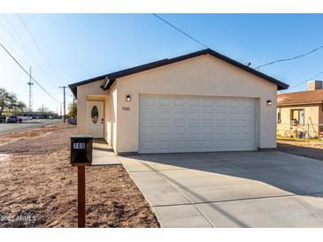 Charming single-story home featuring a two-car garage, desert landscaping and a modern design at 700 N D St, Eloy, AZ 85131