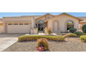 Charming single-story home featuring a low-maintenance front yard and a two-car garage at 9809 W Wescott Dr, Peoria, AZ 85382