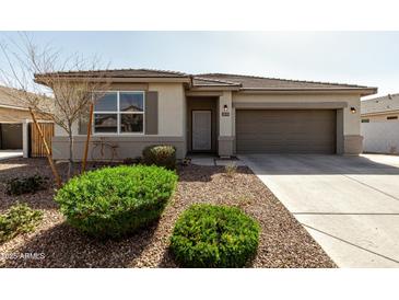 Charming single-story home featuring a well-kept front yard and two-car garage at 1039 W Tuli Way, San Tan Valley, AZ 85143