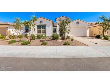 Charming single-story home with a two car garage, landscaped front yard, and neutral color palette at 11807 W Parkway Ln, Avondale, AZ 85323