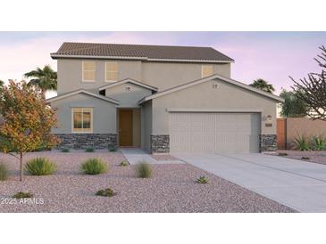 Charming two-story home featuring a two-car garage, stone accents, and drought-tolerant landscaping at 12642 W Parkway Ln, Avondale, AZ 85323