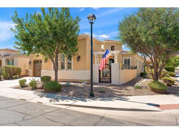 Charming single-Gathering home featuring an American flag, well-maintained landscaping, and inviting curb appeal at 1275 E Verde Blvd, Queen Creek, AZ 85140