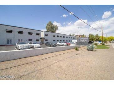 An exterior view of a building with a parking lot in front and a Mountain Springs Terrace sign at 18202 N Cave Creek Rd # 240, Phoenix, AZ 85032