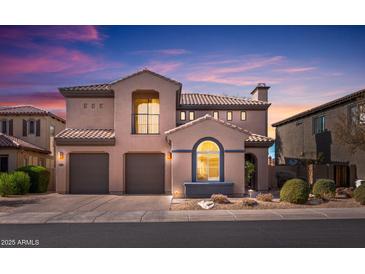 Charming two-story home featuring a tile roof, three-car garage, and manicured landscaping at 22206 N 36Th Way, Phoenix, AZ 85050