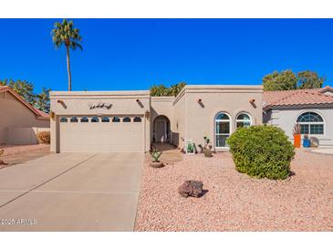 Charming single-story home featuring desert landscaping, attached garage, and covered entryway at 25236 S Lakeway Dr, Sun Lakes, AZ 85248