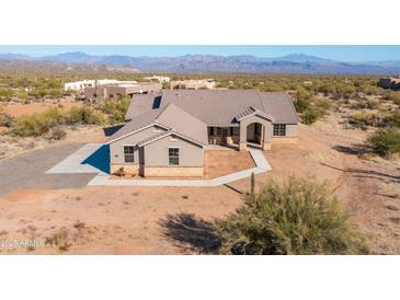 Expansive single-story home showcasing the desert landscape and mountain views at 34515 N 142Nd St, Scottsdale, AZ 85262