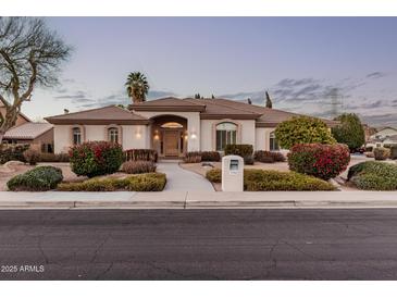 Charming single-story home with neutral paint, a tile roof, and lush landscaping at 3954 E Florian Ave, Mesa, AZ 85206