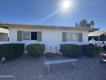 View of the front yard, gravel, seating, and single story structure with awnings at 451 E Franklin Ave, Mesa, AZ 85204