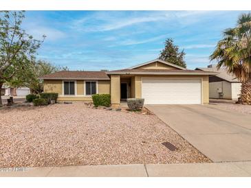 Charming single-story home with low maintenance desert landscaping and a two car garage at 5226 W Freeway Ln, Glendale, AZ 85302