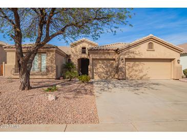 Charming home featuring a tile roof, three-car garage, and low-maintenance desert landscaping at 662 W Raven Dr, Chandler, AZ 85286