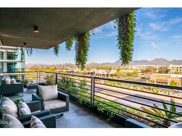 Relaxing balcony with comfortable seating, stunning city and mountain views, and lush hanging plants at 7180 E Kierland Blvd # 508, Scottsdale, AZ 85254