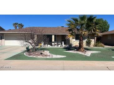 Charming single story home with desert landscaping and an attached garage at 9714 W Terrace Ln, Sun City, AZ 85373