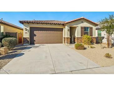 Charming single-story home with desert landscaping, a tiled roof, and a two-car garage at 20056 N 107Th Ln, Peoria, AZ 85373