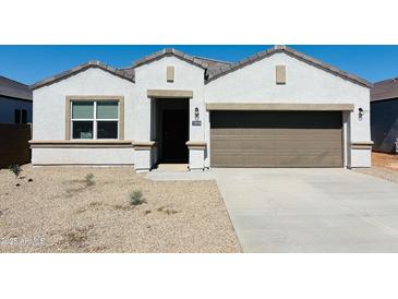 Charming single-story home featuring a neutral color palette, a two-car garage, and low-maintenance desert landscaping at 28228 N Nealite Dr, San Tan Valley, AZ 85143