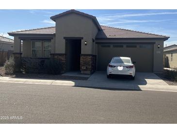 Charming single-story home featuring stone accents and a well-manicured front yard at 3411 W Pollack St, Phoenix, AZ 85041