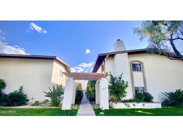 Charming condo with landscaped yard, private entrance, and architectural details, providing an inviting curb appeal at 3637 E Monterosa St # 5, Phoenix, AZ 85018